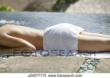 Stock Photography - A woman sun bathing.. Fotosearch