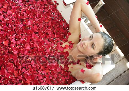 Stock Photo - A young woman having aroma bath.. Fotosearch