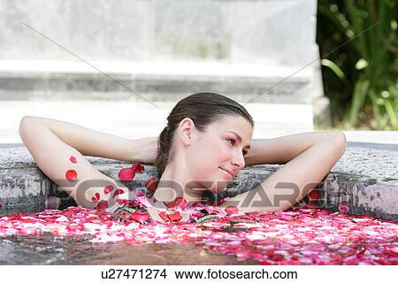 A young woman having aromatherapy bath. View Large Photo Image Picture - A young woman having aromatherapy bath.. Fotosearch