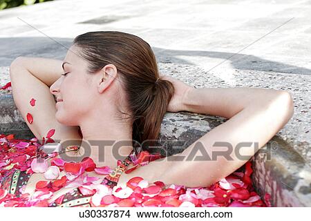 A young woman having aromatherapy bath. View Large Photo Image Picture - A young woman having aromatherapy bath.. Fotosearch