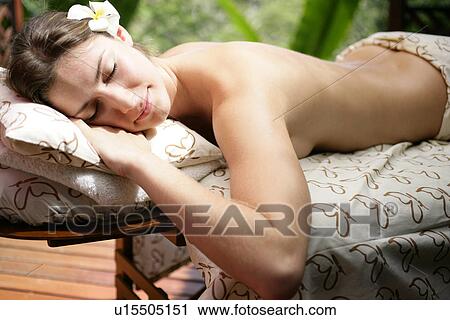 A young woman lying on table with eyes closed. View Large Photo Image Stock Image - A young woman lying on table with eyes closed.. Fotosearch
