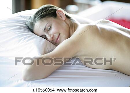 A young woman lying with eyes closed. View Large Photo Image Picture - A young woman lying with eyes closed.. Fotosearch