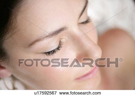 A young woman lying with eyes closed. View Large Photo Image Stock Photo - A young woman lying with eyes closed.. Fotosearch
