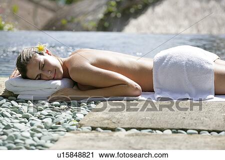 A young woman sun bathing. View Large Photo Image Stock Image - A young woman sun bathing.. Fotosearch