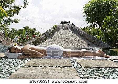 A young woman sun bathing. View Large Photo Image Stock Image - A young woman sun bathing.. Fotosearch
