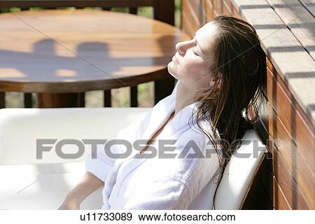 A young woman sun bathing. View Large Photo Image Stock Photo - A young woman sun bathing.. Fotosearch