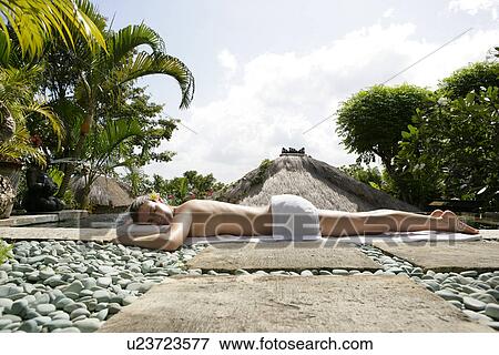 A young woman sun bathing. View Large Photo Image Stock Photo - A young woman sun bathing.. Fotosearch