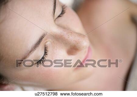 Stock Photo - A young woman with eyes closed.. Fotosearch