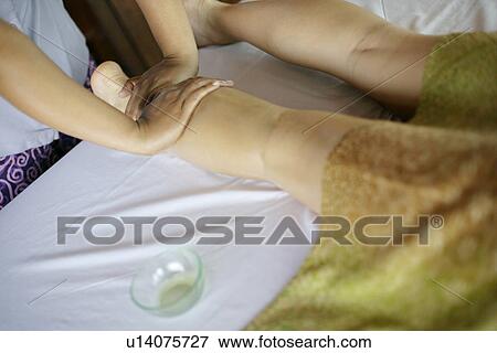 Close-up of a person massaging a woman’s leg. View Large Photo Image Stock Photo - Close-up of a person massaging a woman’s leg.. Fotosearch