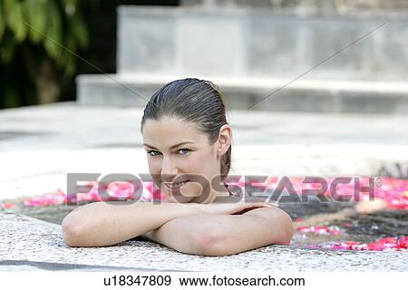 Portrait of a young woman having aromatherapy bath. View Large Photo Image Stock Photo - Portrait of a young woman having aromatherapy bath.. Fotosearch