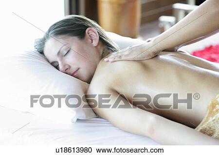Side view of a young woman getting massage. View Large Photo Image Stock Image - Side view of a young woman getting massage.. Fotosearch