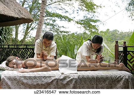 View of a young woman taking massage in a health spa. View Large Photo Image Stock Photo - View of a young woman taking massage in a health spa.. Fotosearch