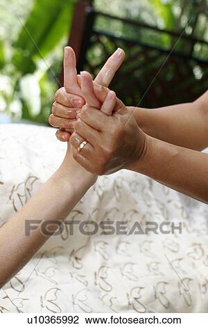 A massage therapist massaging hands and fingers. View Large Photo Image Stock Image - A massage therapist massaging hands and fingers.. Fotosearch