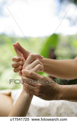 A massage therapist massaging hands and fingers. View Large Photo Image Stock Photography - A massage therapist massaging hands and fingers.. Fotosearch