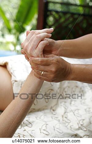 Stock Image - A massage therapist massaging hands.. Fotosearch