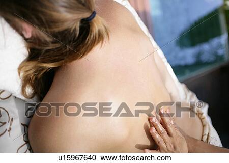 A person massaging a woman’s back. View Large Photo Image Stock Image - A person massaging a woman’s back.. Fotosearch