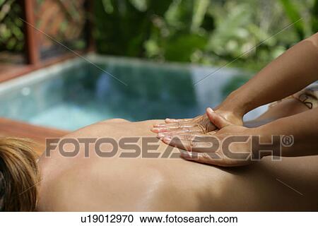 A person massaging a young woman’s back. View Large Photo Image Stock Image - A person massaging a young woman’s back.. Fotosearch