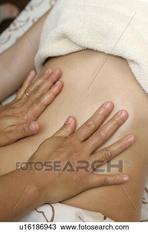 A woman having massage by a massage therapist. View Large Photo Image Stock Image - A woman having massage by a massage therapist.. Fotosearch