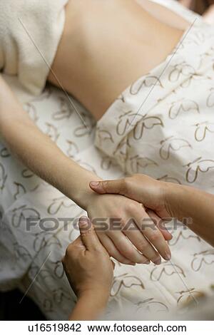 A woman having massage by a massage therapist. View Large Photo Image Stock Image - A woman having massage by a massage therapist.. Fotosearch