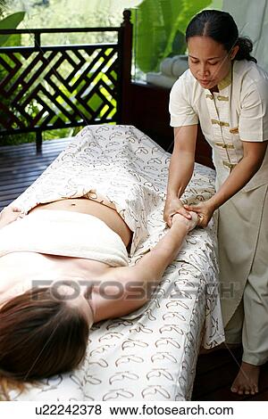 Stock Photo - A woman having massage by a masseuse.. Fotosearch