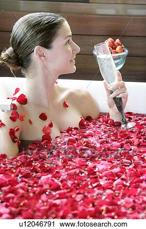 A young woman having aromatherapy bath with a drink. View Large Photo Image Stock Image - A young woman having aromatherapy bath with a drink.. Fotosearch