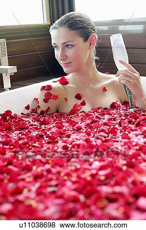 A young woman having aromatherapy bath with a drink. View Large Photo Image Stock Photo - A young woman having aromatherapy bath with a drink.. Fotosearch
