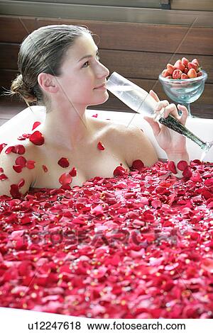 A young woman having aromatherapy bath with a drink. View Large Photo Image Stock Photo - A young woman having aromatherapy bath with a drink.. Fotosearch