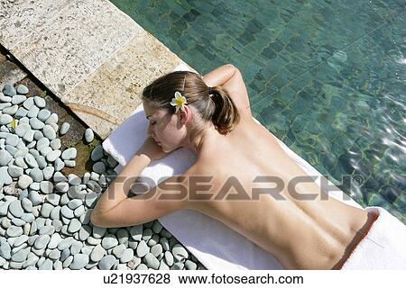 A young woman sun bathing. View Large Photo Image Stock Photo - A young woman sun bathing.. Fotosearch