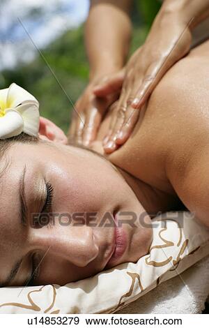 Stock Photo - Close-up of a young woman having massage on her back.. Fotosearch