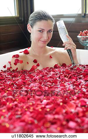 Stock Photography - Portrait of a young woman having aromatherapy bath.. Fotosearch