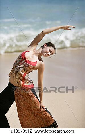 A woman exercising on a beach. View Large Photo Image Stock Image - A woman exercising on a beach.. Fotosearch