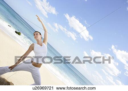 A woman exercising on a beach. View Large Photo Image Stock Image - A woman exercising on a beach.. Fotosearch