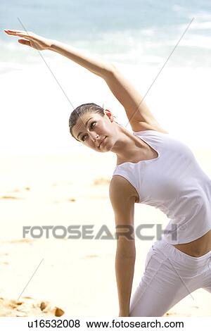 A woman exercising on a beach. View Large Photo Image Stock Photo - A woman exercising on a beach.. Fotosearch