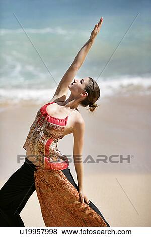 A woman exercising on a beach. View Large Photo Image Stock Photo - A woman exercising on a beach.. Fotosearch