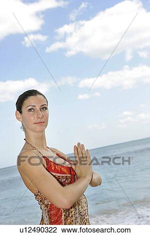 A woman on a beach with joined hands. View Large Photo Image Stock Image - A woman on a beach with joined hands.. Fotosearch