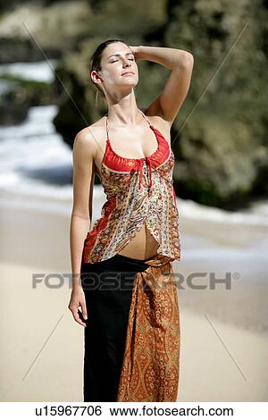 A woman standing on a beach. View Large Photo Image Stock Photograph - A woman standing on a beach.. Fotosearch