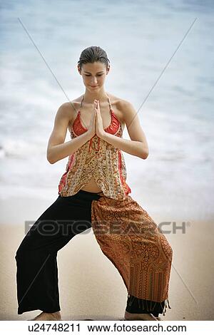 A woman standing on a beach with joined hands. View Large Photo Image Stock Image - A woman standing on a beach with joined hands.. Fotosearch