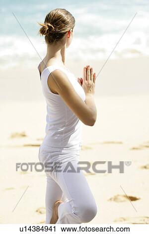 A woman standing with joined hands on a beach. View Large Photo Image Stock Image - A woman standing with joined hands on a beach.. Fotosearch