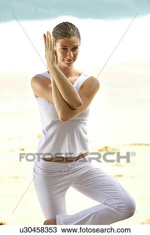 A woman standing with joined hands on a beach. View Large Photo Image Stock Image - A woman standing with joined hands on a beach.. Fotosearch