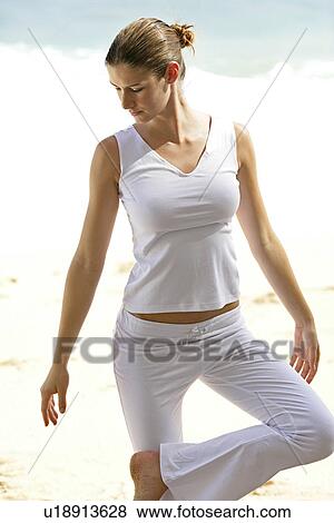 A woman standing with joined hands on a beach. View Large Photo Image Stock Photo - A woman standing with joined hands on a beach.. Fotosearch
