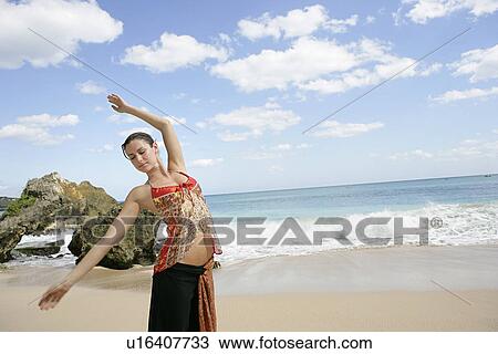 A young woman dancing on a shore. View Large Photo Image Stock Image - A young woman dancing on a shore.. Fotosearch