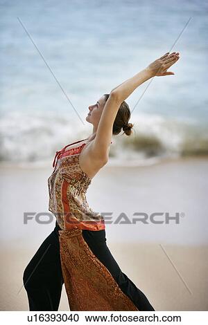 View of a woman exercising on a beach. View Large Photo Image Stock Image - View of a woman exercising on a beach.. Fotosearch