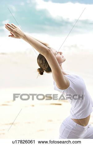 View of a woman exercising on a beach. View Large Photo Image Stock Image - View of a woman exercising on a beach.. Fotosearch