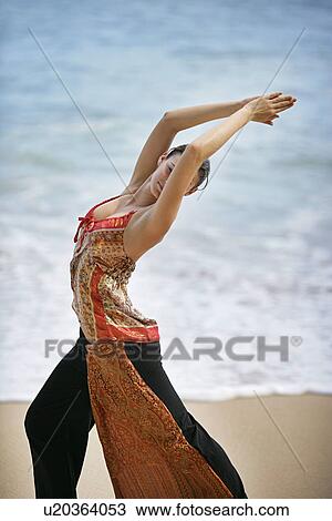 View of a woman exercising on a beach. View Large Photo Image Stock Image - View of a woman exercising on a beach.. Fotosearch