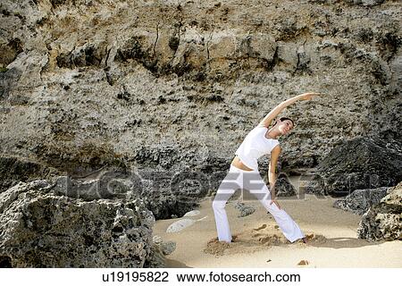 Stock Image - View of a woman exercising outdoor.. Fotosearch
