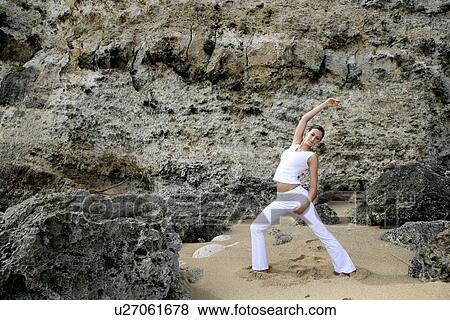 Stock Photo - View of a woman exercising outdoor.. Fotosearch