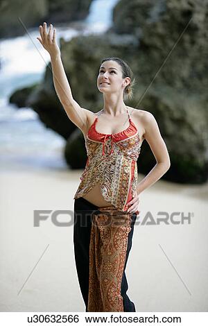 View of a woman performing on a beach. View Large Photo Image Stock Photograph - View of a woman performing on a beach.. Fotosearch