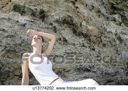 View of a woman shielding her eyes. View Large Photo Image Stock Image - View of a woman shielding her eyes.. Fotosearch