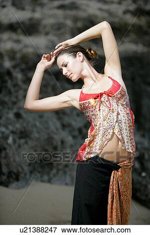 View of a woman standing with arms raised. View Large Photo Image Stock Photo - View of a woman standing with arms raised.. Fotosearch