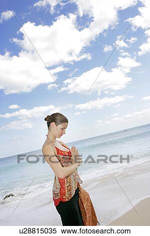 View of a woman with joined hands on a beach. View Large Photo Image Stock Photography - View of a woman with joined hands on a beach.. Fotosearch